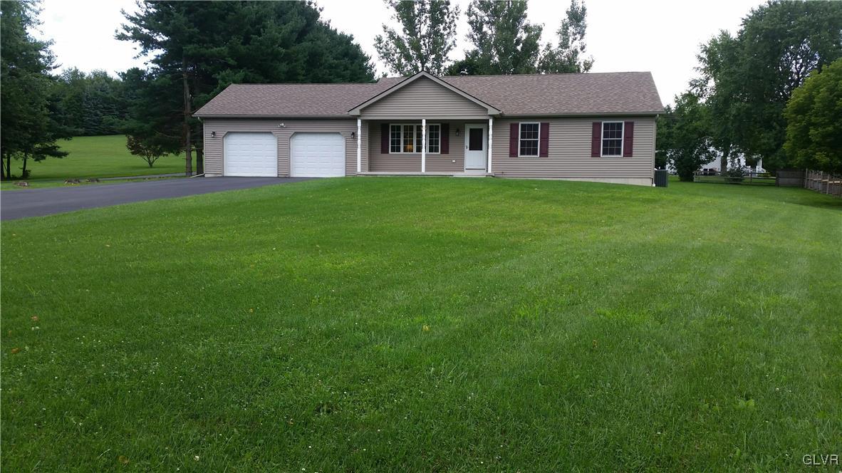 889 North Summit Road Bath, PA 18014 - Photo 1 of 6 a view of a house next to a big yard and large trees