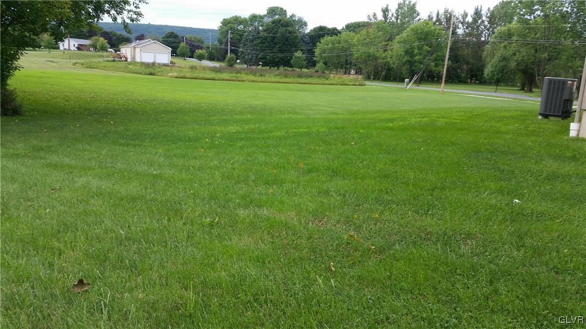 889 North Summit Road Bath, PA 18014 - Photo 2 of 6 a backyard of a house with lots of green space and outdoor seating