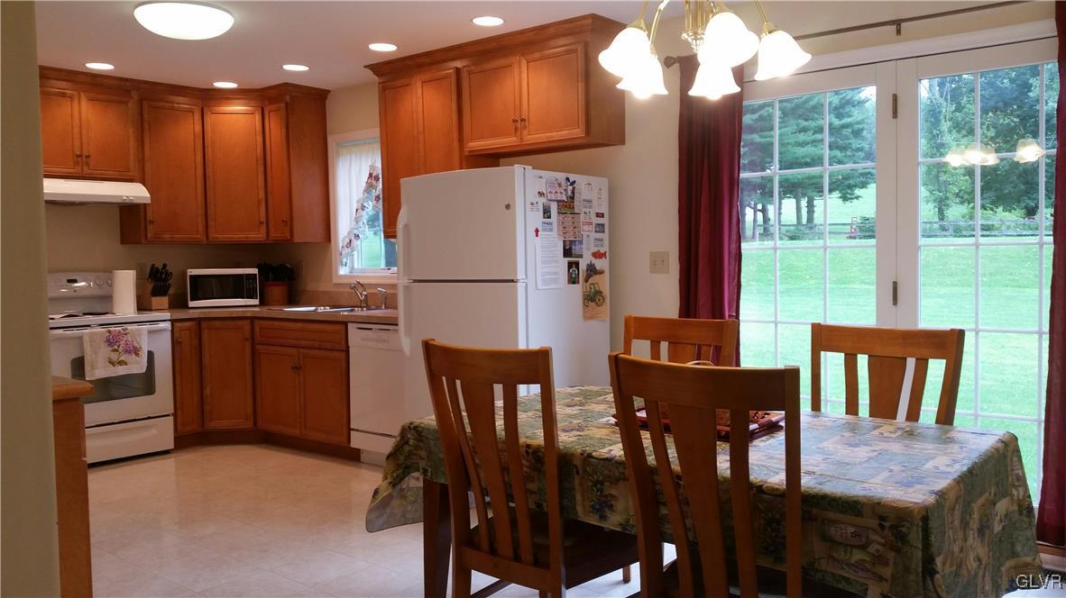 889 North Summit Road Bath, PA 18014 - Photo 4 of 6 a kitchen with a table chairs refrigerator and microwave