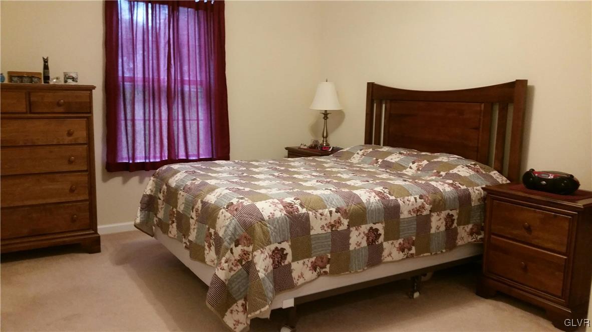 889 North Summit Road Bath, PA 18014 - Photo 6 of 6 a bed sitting in a bedroom next to a window and red walls