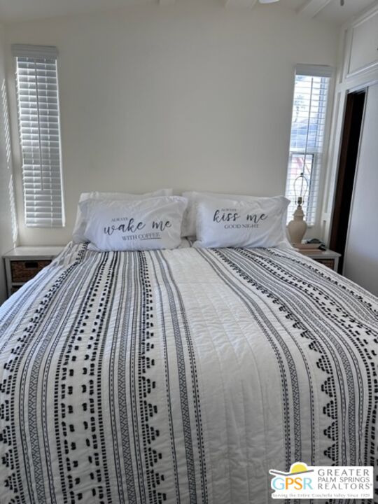 69801 Ramon Road, Unit 161 Cathedral City, CA 92234 - Photo 7 of 9 a bedroom with a bed next to a window