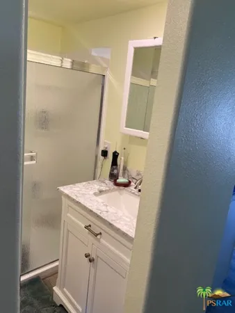 a bathroom with a sink a vanity and a mirror