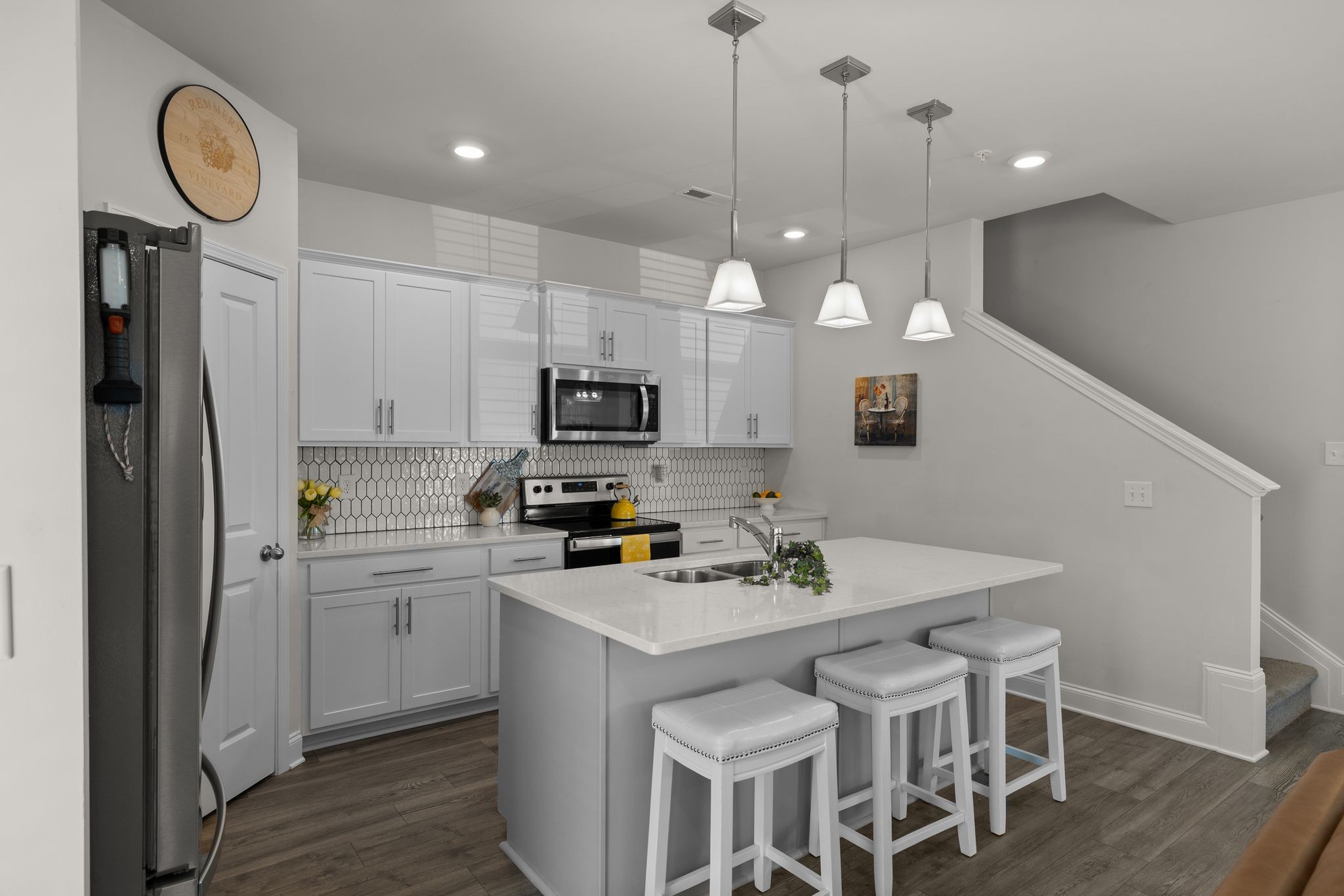 1247 June Wilde Ridge Spring Hill, TN 37174 - Photo 11 of 47 a kitchen with kitchen island granite countertop a sink a center island a counter space and stainless steel appliances