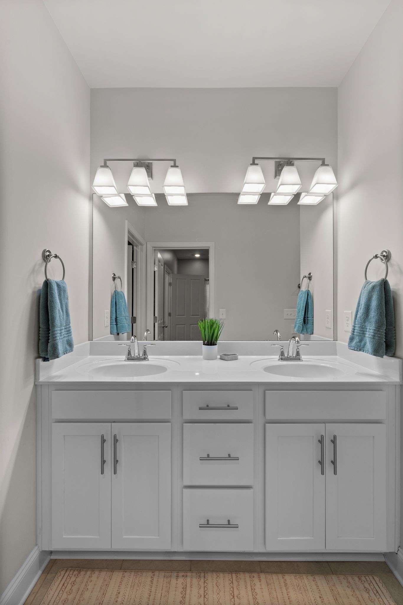 1247 June Wilde Ridge Spring Hill, TN 37174 - Photo 19 of 47 a bathroom with a double vanity sink and a mirror