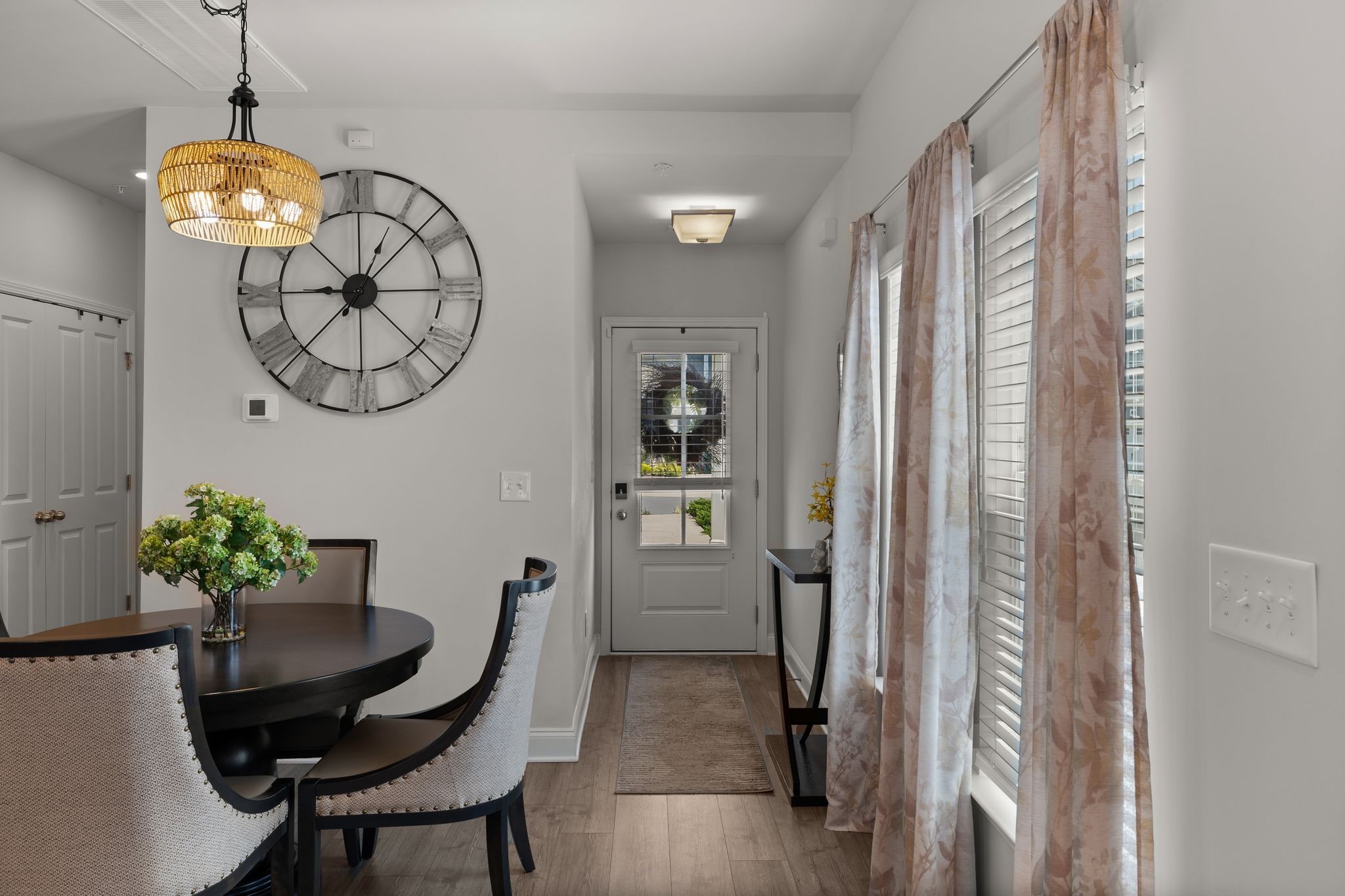 1247 June Wilde Ridge Spring Hill, TN 37174 - Photo 6 of 47 a view of a hallway and dining room with furniture wooden floor and a chandelier