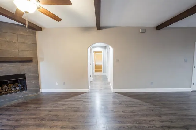 wooden floor in an empty room with a window