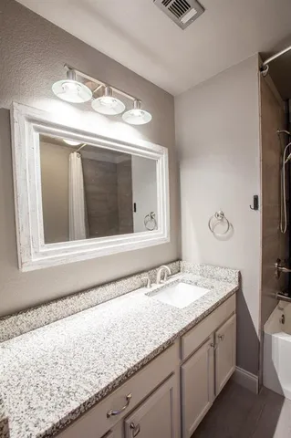 an empty room with a window and a ceiling fan