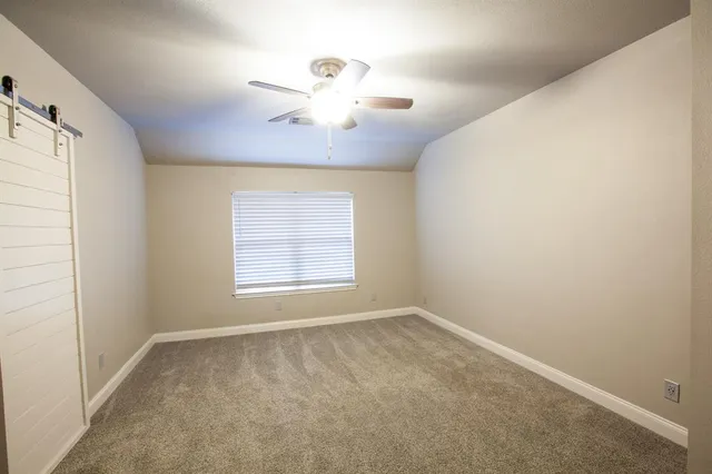 a view of an empty room with a fan