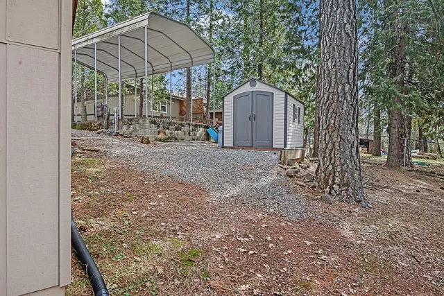 a view of a house with a yard covered in snow
