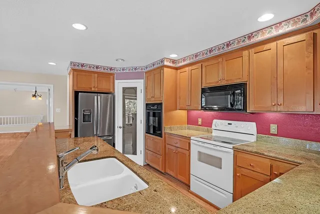 a kitchen that has a sink and a stove in it