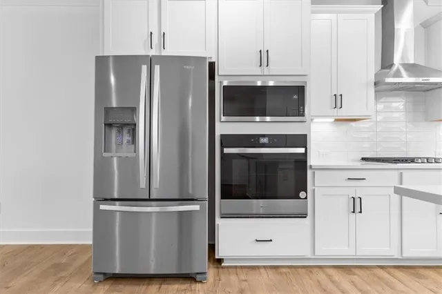 a kitchen with stainless steel appliances sink refrigerator and microwave