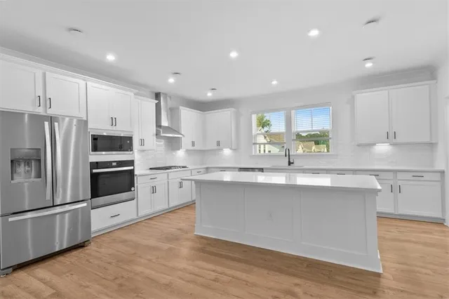 a kitchen with stainless steel appliances granite countertop a sink and cabinets