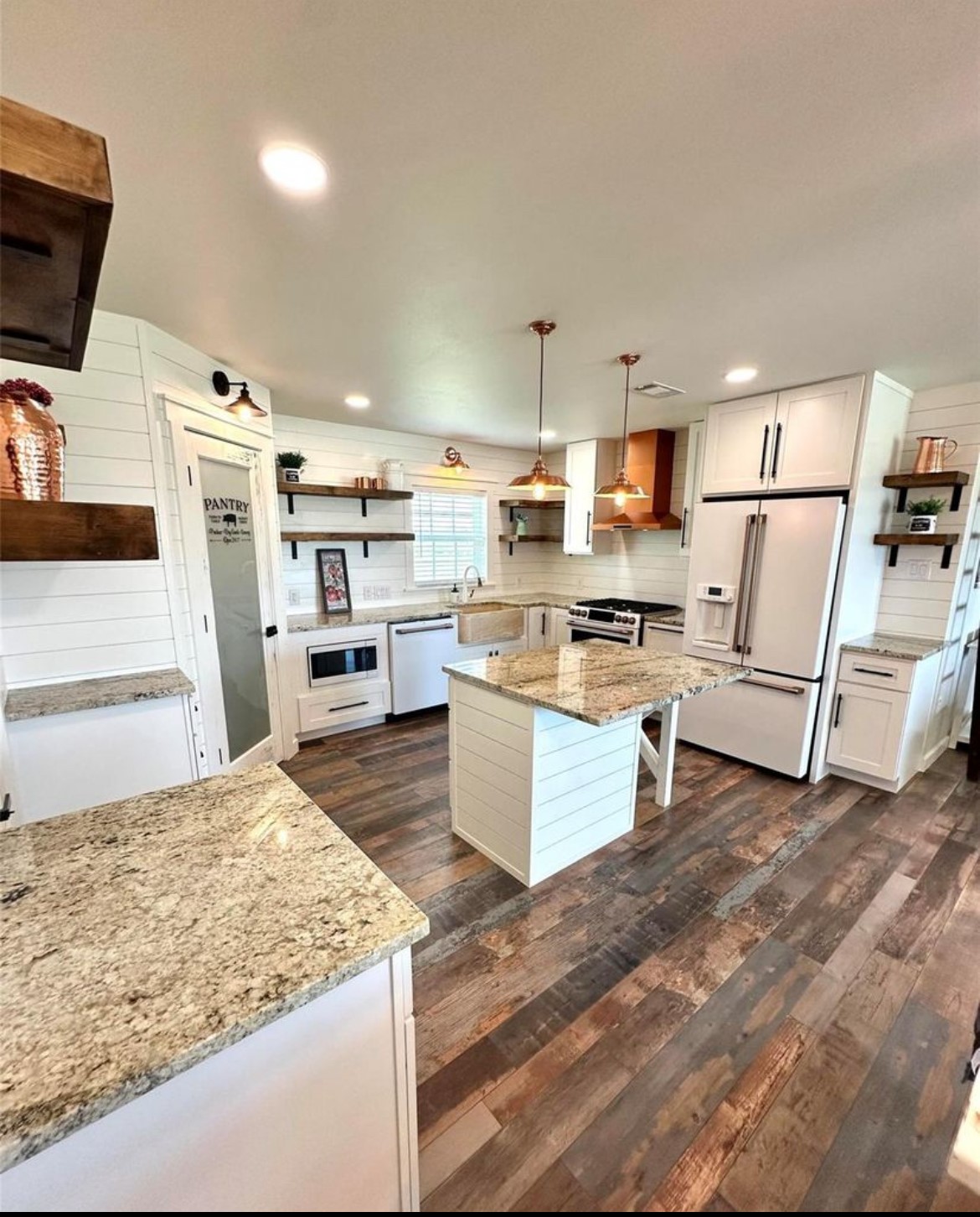 518 Anton Stade Road, Unit B Rosenberg, TX 77471 - Photo 5 of 11 a kitchen with stainless steel appliances kitchen island granite countertop a stove and a sink