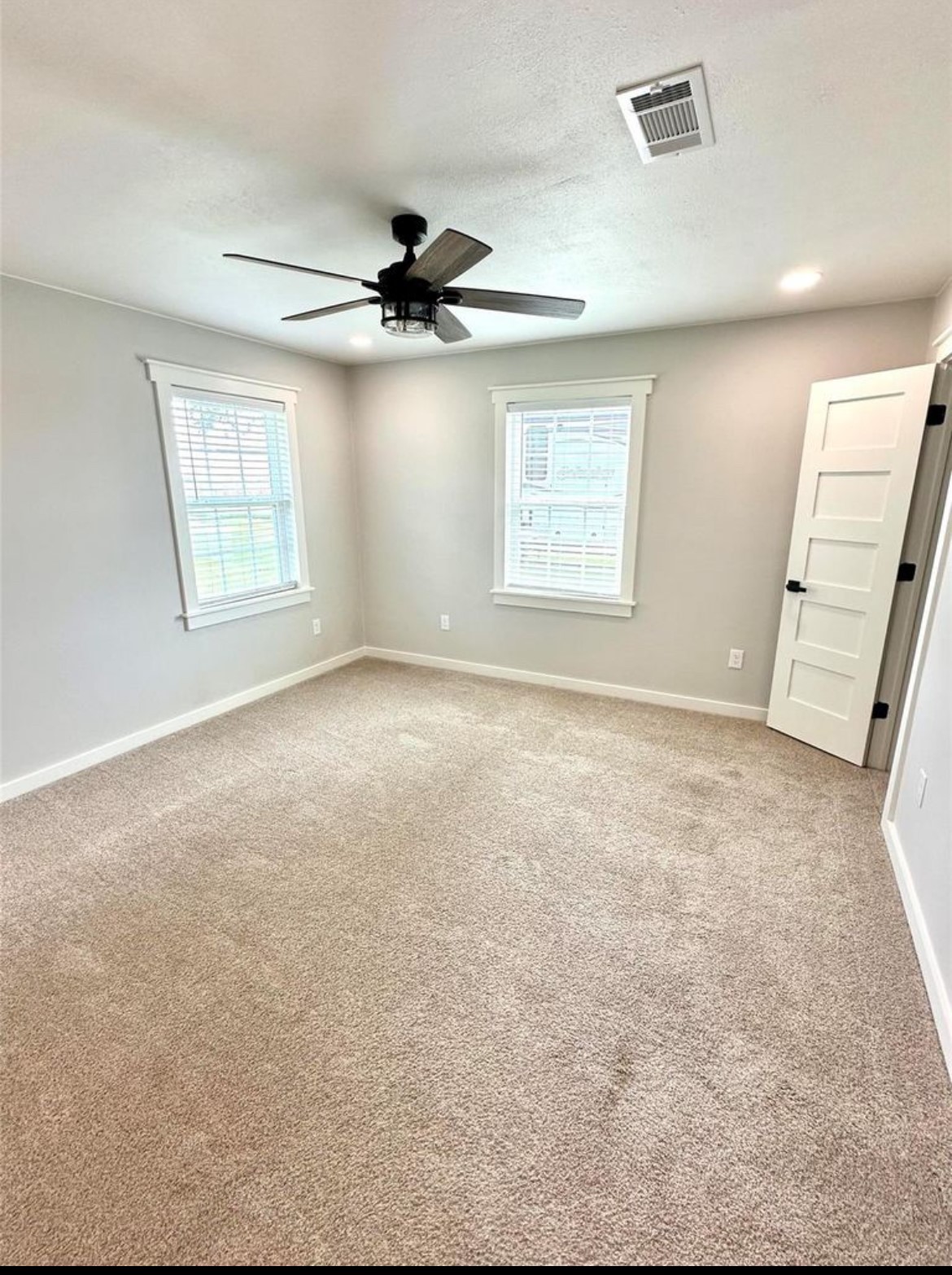 518 Anton Stade Road, Unit B Rosenberg, TX 77471 - Photo 9 of 11 an empty room with windows and fan