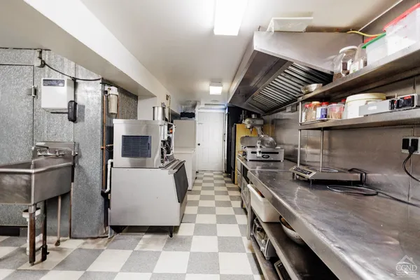 a kitchen with stainless steel appliances a sink a stove a refrigerator and cabinets