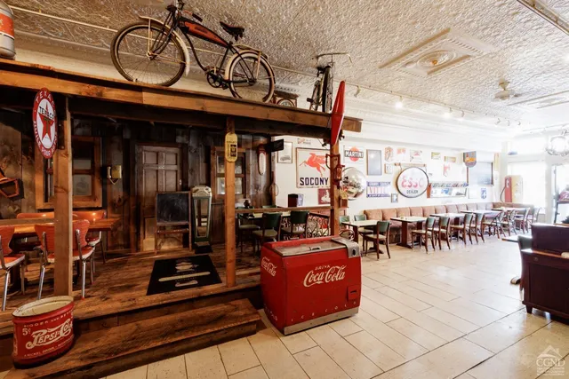 a view of a cafe with sitting area