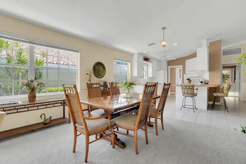 a view of a dining room with furniture and a large window