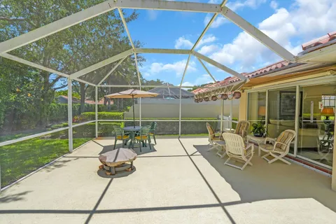 a view of a patio with a table and chairs