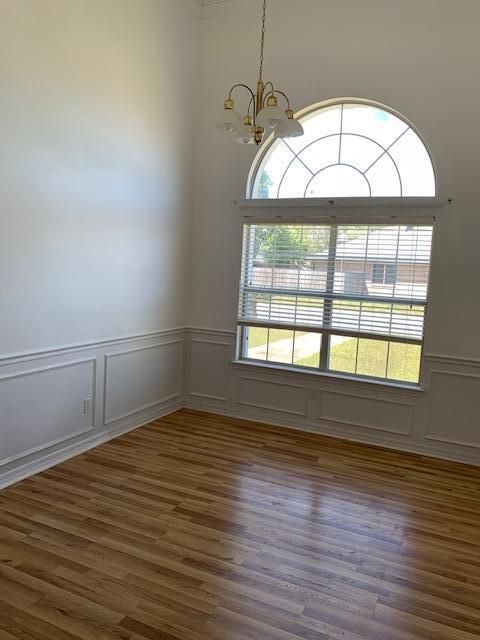 136 Gail La Rue Fort Walton Beach, FL 32547 - Photo 6 of 31 an empty room with wooden floor and windows