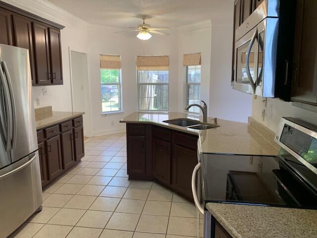 136 Gail La Rue Fort Walton Beach, FL 32547 - Photo 7 of 31 a kitchen with kitchen island granite countertop a sink stove and refrigerator