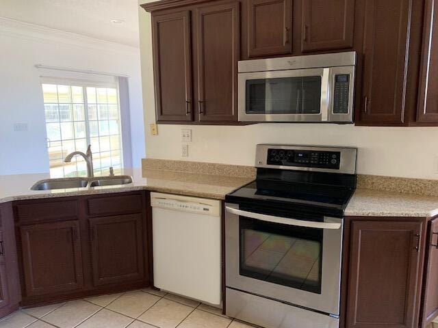 136 Gail La Rue Fort Walton Beach, FL 32547 - Photo 9 of 31 a kitchen with a stove and a microwave