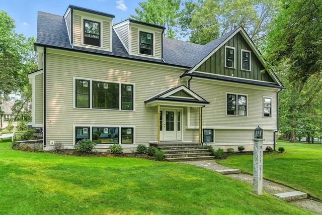 a front view of a house with a garden