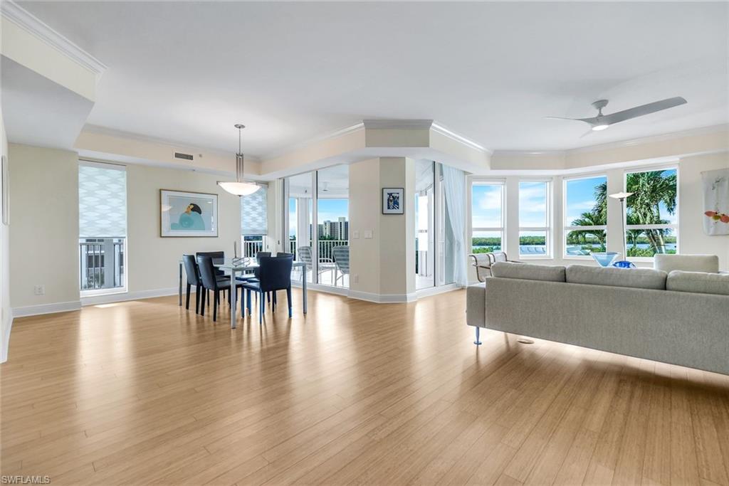 285 Grande Way, Unit 401 Naples, FL 34110 - Photo 12 of 50 a living room with furniture and a wooden floor