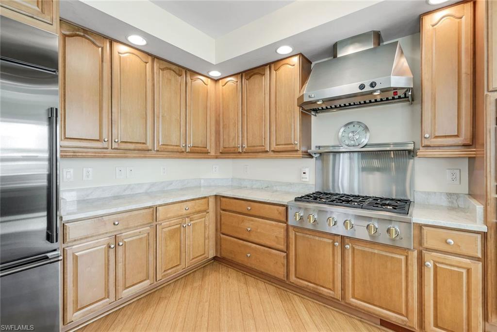 285 Grande Way, Unit 401 Naples, FL 34110 - Photo 16 of 50 a kitchen with cabinets appliances and a counter space