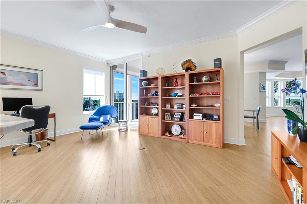 285 Grande Way, Unit 401 Naples, FL 34110 - Photo 20 of 50 a view of a workspace with furniture and wooden floor