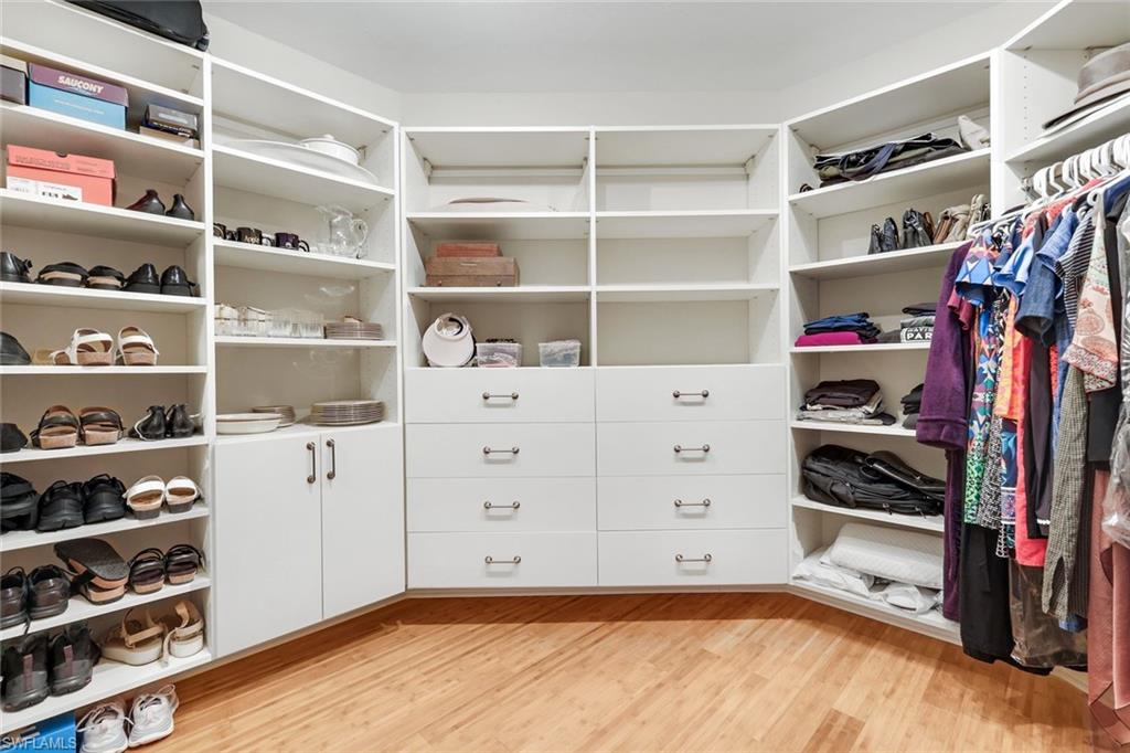 285 Grande Way, Unit 401 Naples, FL 34110 - Photo 24 of 50 a view of walk in closet with clothes and shoes