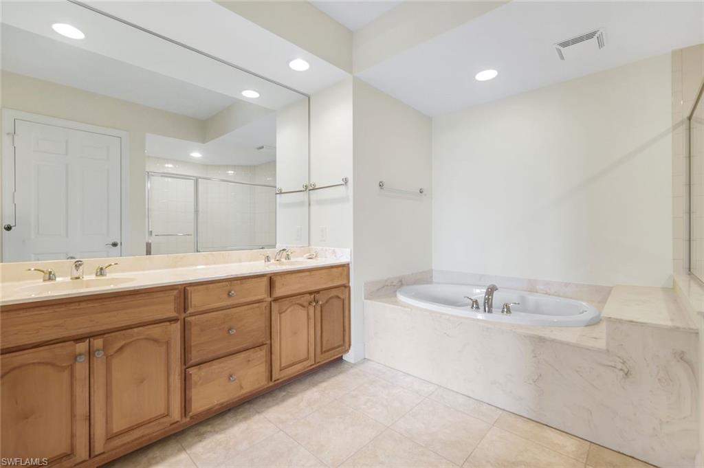 285 Grande Way, Unit 401 Naples, FL 34110 - Photo 28 of 50 a bathroom with a double vanity sink mirror and double