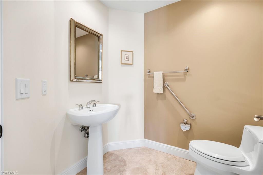 285 Grande Way, Unit 401 Naples, FL 34110 - Photo 34 of 50 a bathroom with a sink mirror toilet and shower