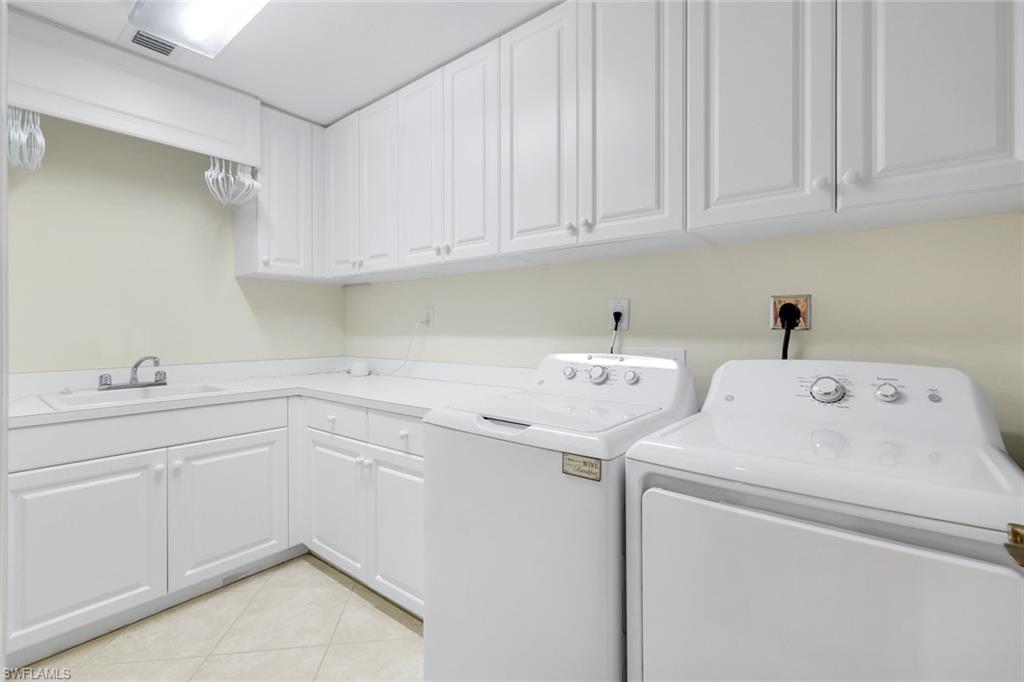 285 Grande Way, Unit 401 Naples, FL 34110 - Photo 35 of 50 a utility room with dryer and washer
