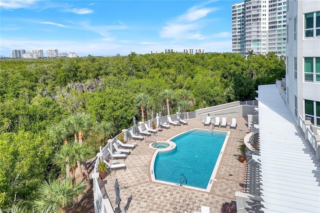285 Grande Way, Unit 401 Naples, FL 34110 - Photo 40 of 50 a view of a balcony with table and chairs