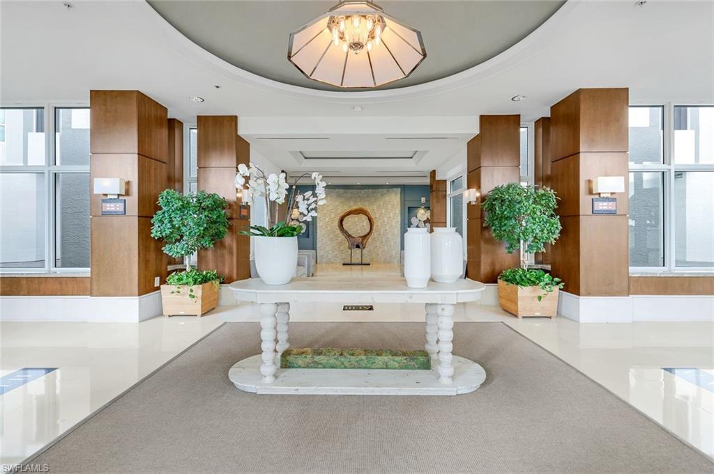 285 Grande Way, Unit 401 Naples, FL 34110 - Photo 6 of 50 a view of living room with furniture and a chandelier