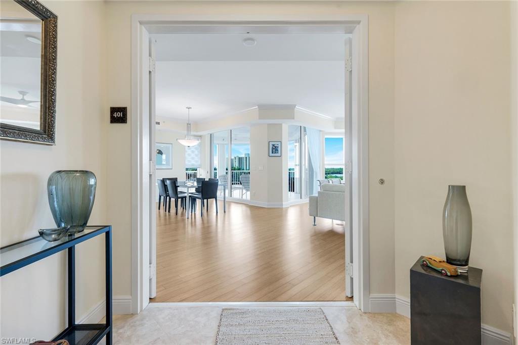 285 Grande Way, Unit 401 Naples, FL 34110 - Photo 8 of 50 a view of a hallway with furniture and a mirror