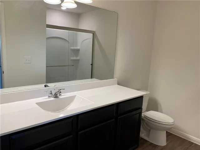 a kitchen with stainless steel appliances a stove top oven a sink with wooden floors