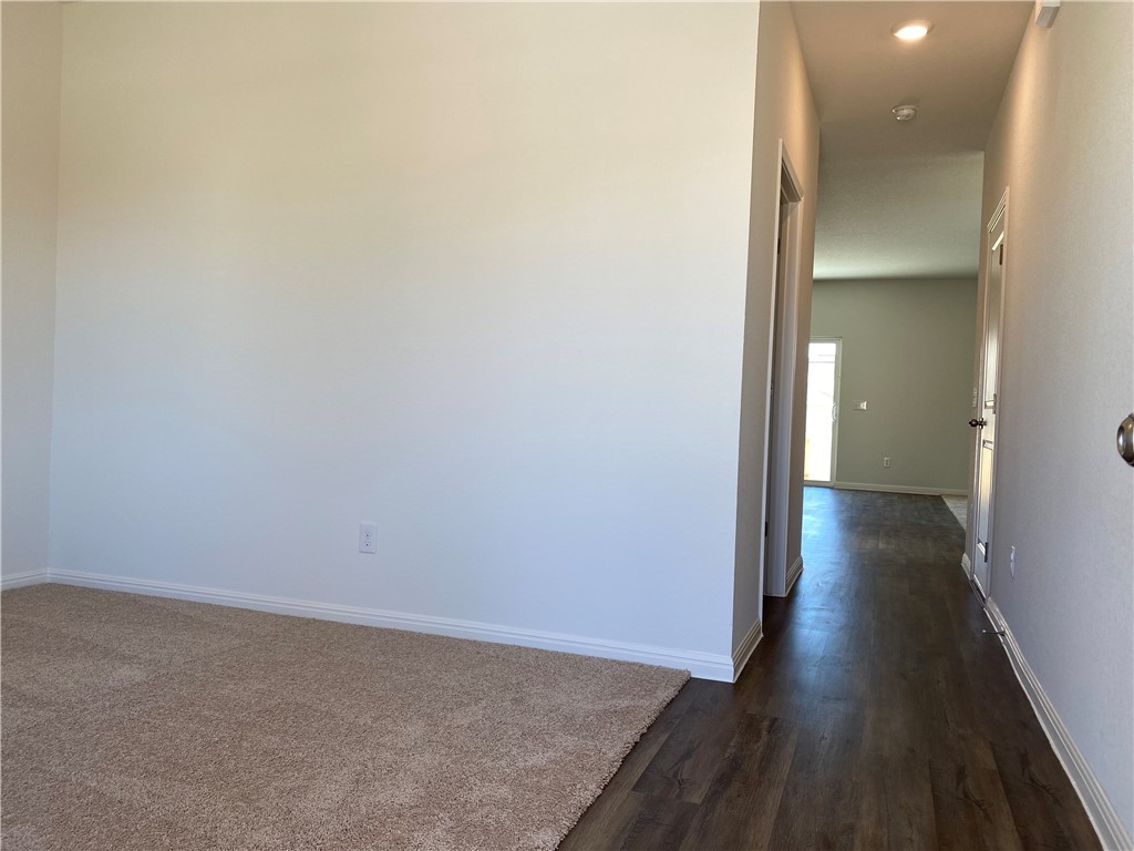 12901 Robert Lafollette Road Manor, TX 78653 - Photo 19 of 29 a view of a hallway with wooden floor