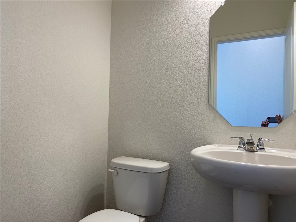 12901 Robert Lafollette Road Manor, TX 78653 - Photo 20 of 29 a bathroom with a toilet a sink and mirror