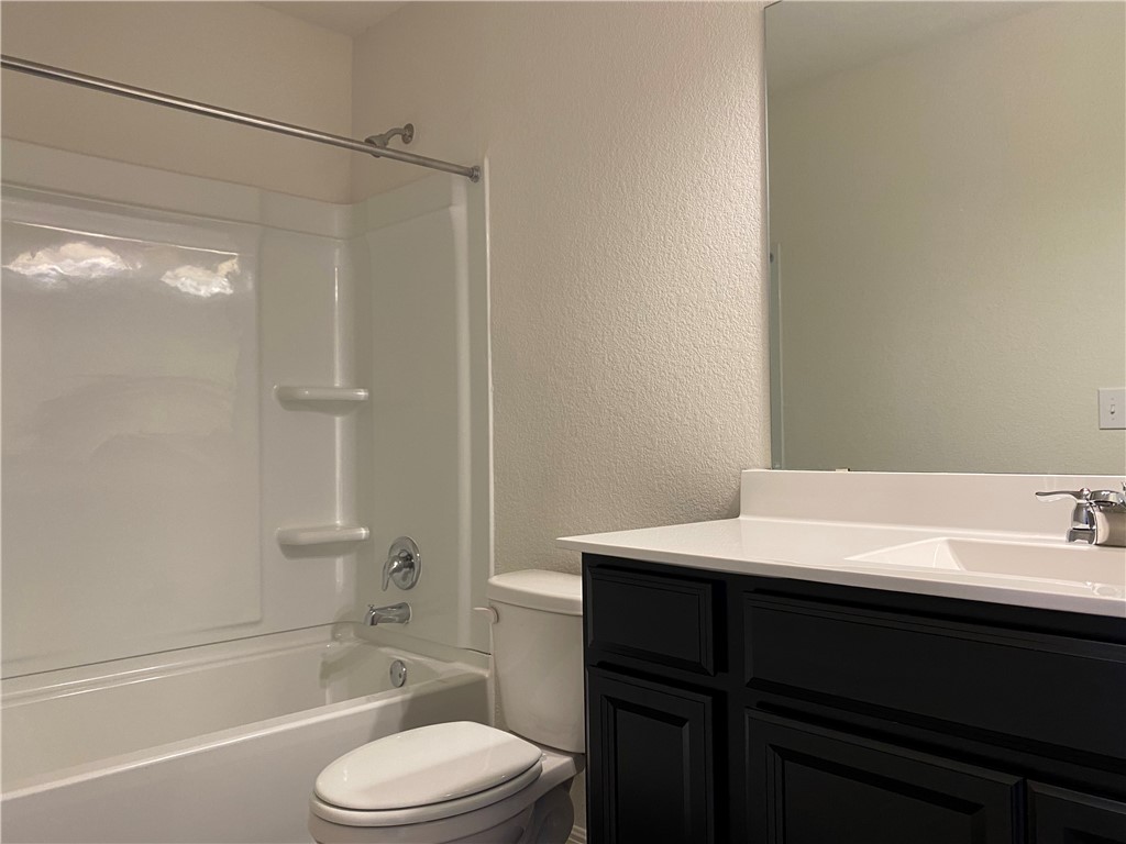 12901 Robert Lafollette Road Manor, TX 78653 - Photo 28 of 29 a bathroom with a sink a toilet and shower
