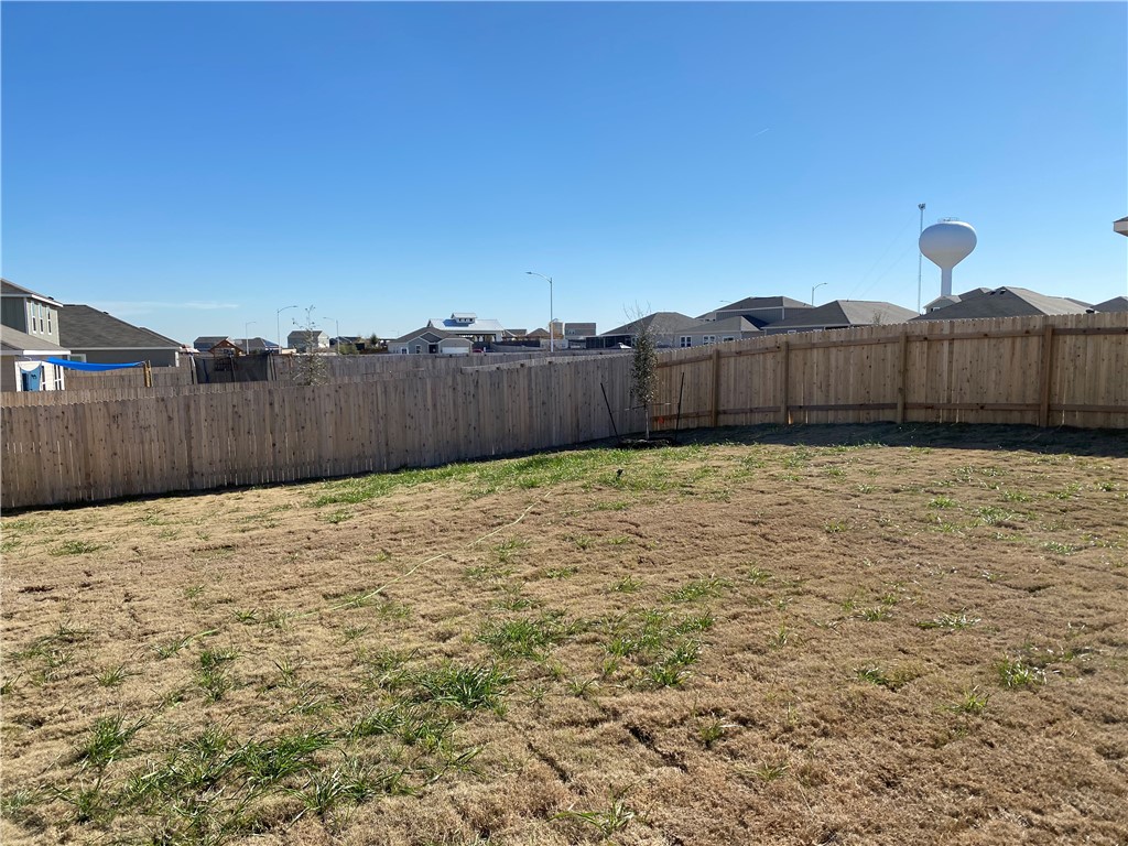 12901 Robert Lafollette Road Manor, TX 78653 - Photo 29 of 29 a view of a backyard with wooden fence