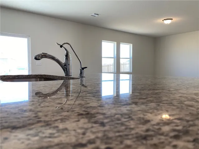 a kitchen with granite countertop sink and granite top