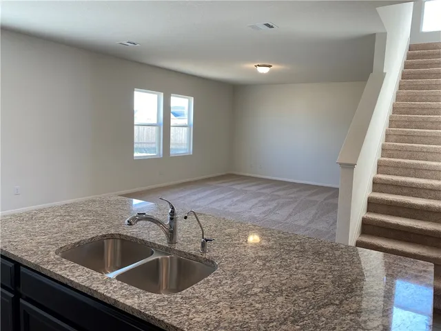 a kitchen with stainless steel appliances a refrigerator and a counter space