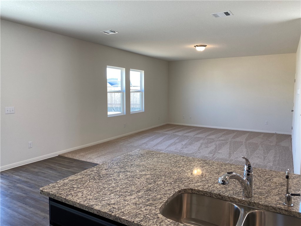 12901 Robert Lafollette Road Manor, TX 78653 - Photo 9 of 29 a kitchen with granite countertop sink and granite top