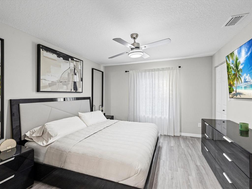 4367 Har Paul Circle Tampa, FL 33614 - Photo 17 of 31 a bedroom with a large bed and a chandelier