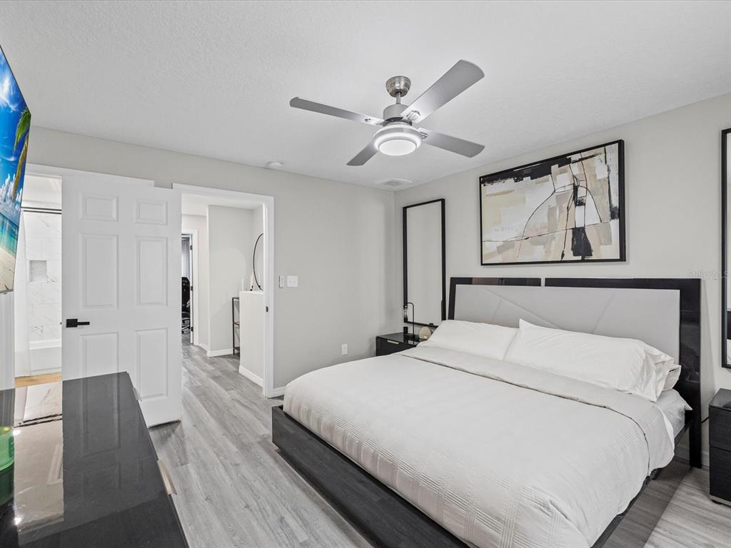 4367 Har Paul Circle Tampa, FL 33614 - Photo 18 of 31 a bedroom with a large bed and a chandelier