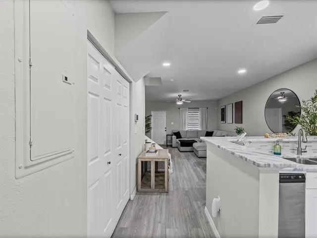 a very nice looking dining room with a large window and stainless steel appliances