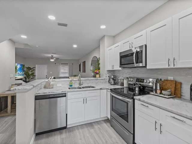 a kitchen with a sink stove and microwave