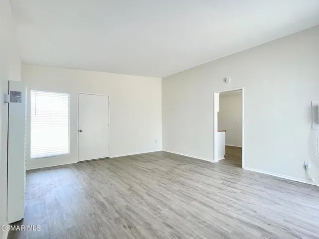 a view of an empty room and wooden floor