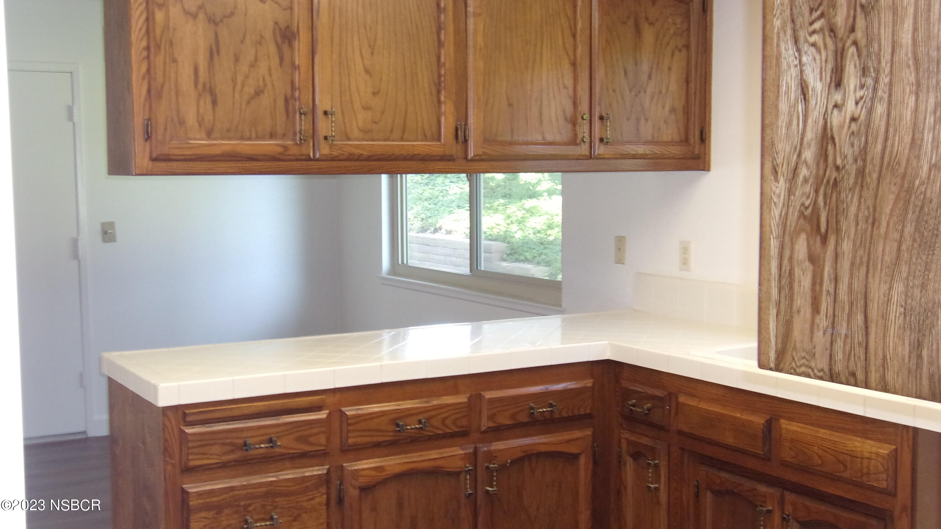 46 Stanford Circle Lompoc, CA 93436 - Photo 14 of 24 a kitchen with granite countertop cabinets and window